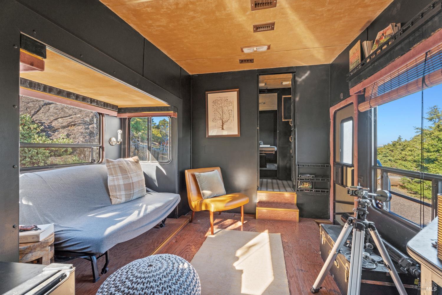 6775 County Road 110 Hopland, CA 95449 - Photo 7 of 53 a living room with furniture a rug and a floor to ceiling window