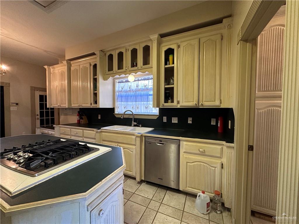 1215 South Tower Road Alamo, TX 78516 - Photo 11 of 41 a kitchen with a stove and a refrigerator