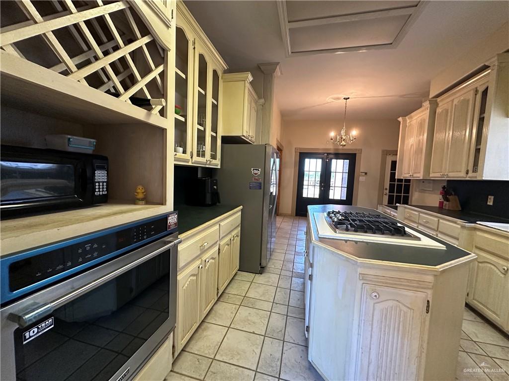 1215 South Tower Road Alamo, TX 78516 - Photo 12 of 41 a kitchen with stainless steel appliances granite countertop a stove and a sink