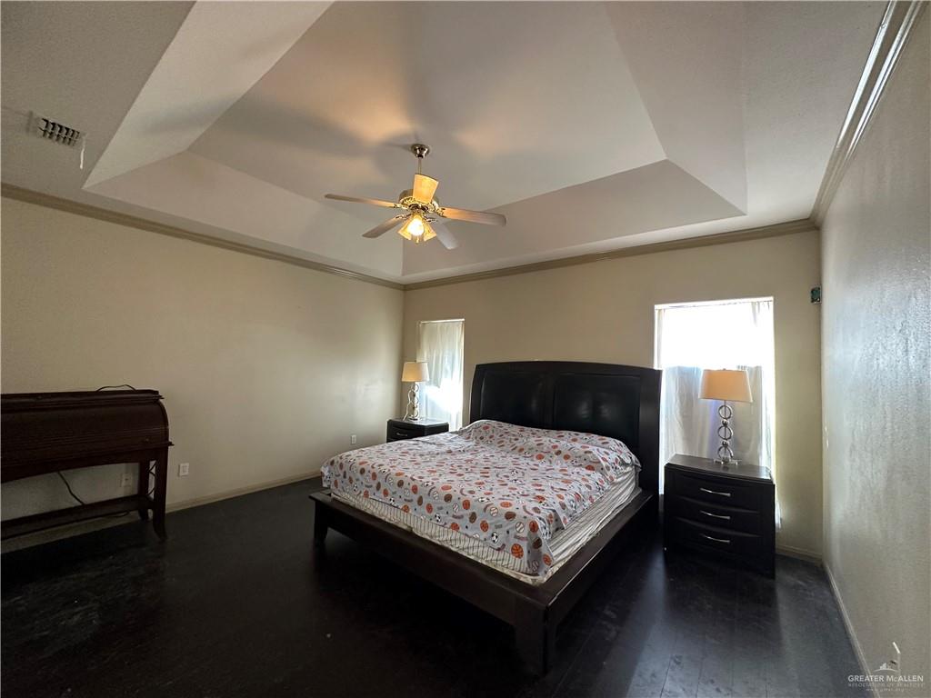 1215 South Tower Road Alamo, TX 78516 - Photo 17 of 41 a bedroom with a bed and a chandelier