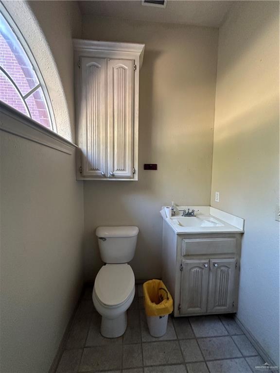 1215 South Tower Road Alamo, TX 78516 - Photo 28 of 41 a bathroom with a toilet a sink and mirror