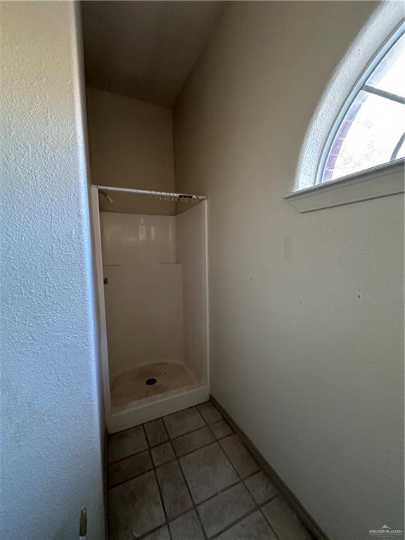 1215 South Tower Road Alamo, TX 78516 - Photo 29 of 41 a bathroom with a glass door shower and a sink