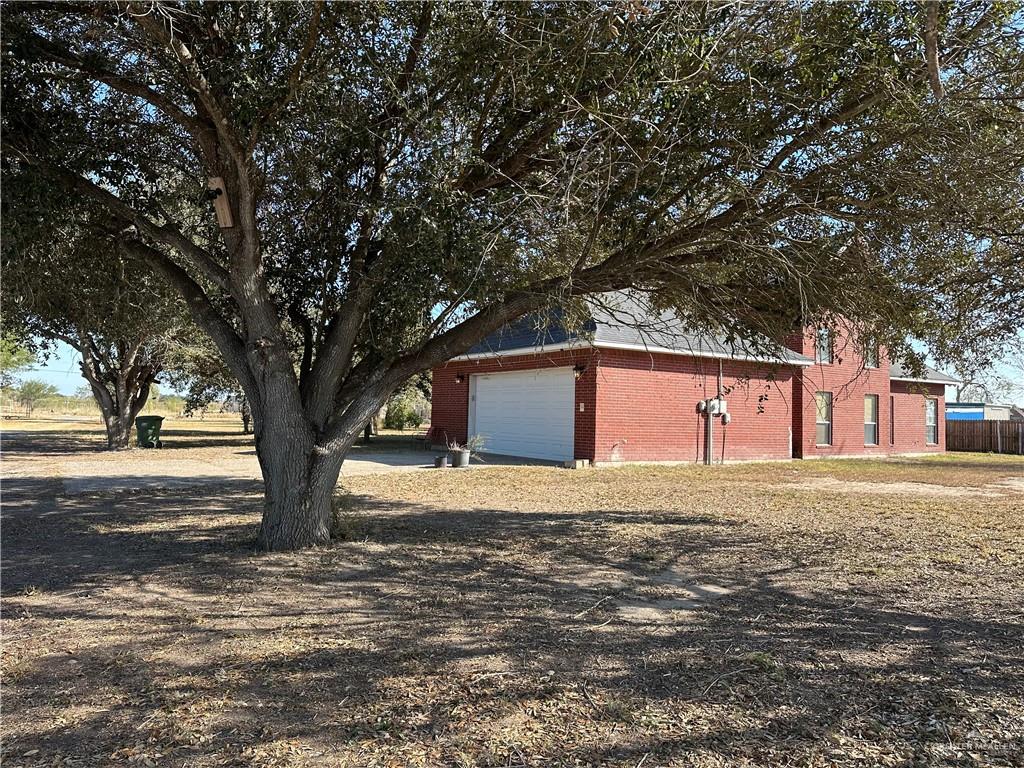 1215 South Tower Road Alamo, TX 78516 - Photo 37 of 41 a white house that has a tree in front of it