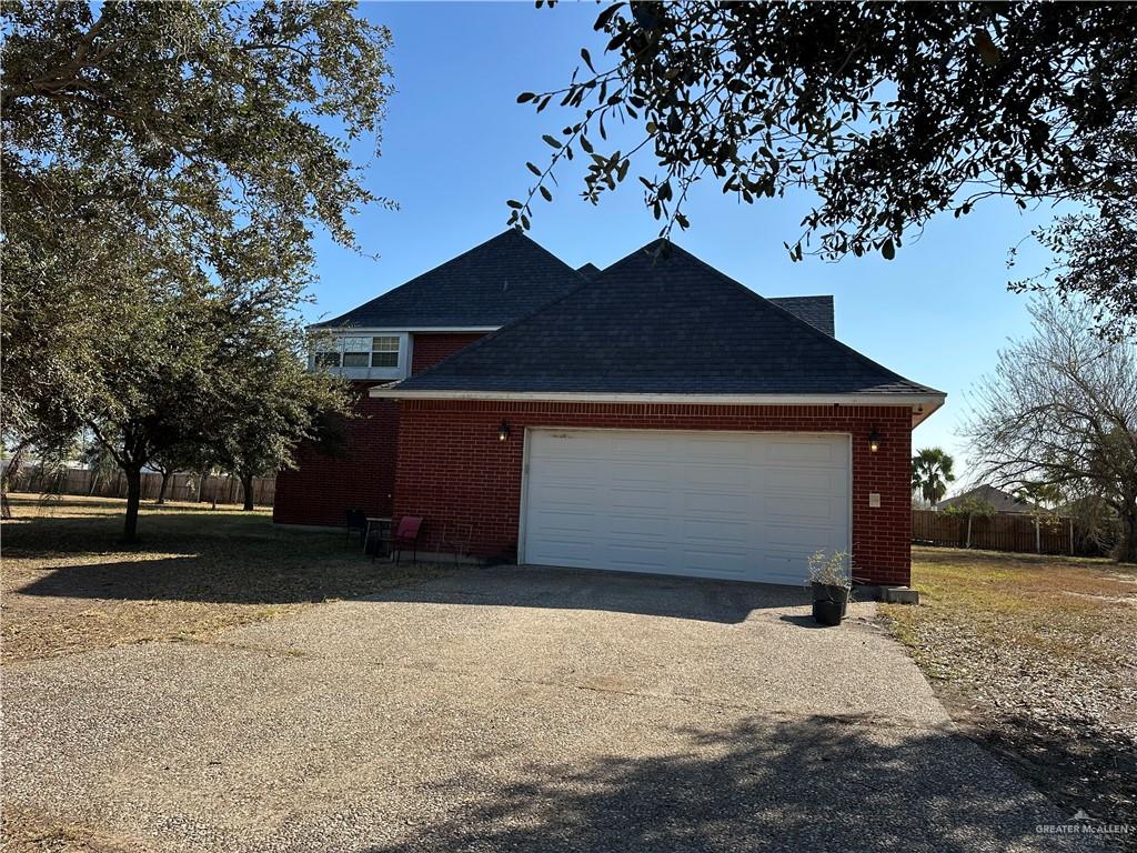 1215 South Tower Road Alamo, TX 78516 - Photo 40 of 41 a front view of house with yard and trees