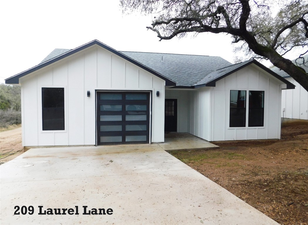 209 Laurel Lane Spicewood, TX 78669 - Photo 1 of 1 a view of house with a yard and garage
