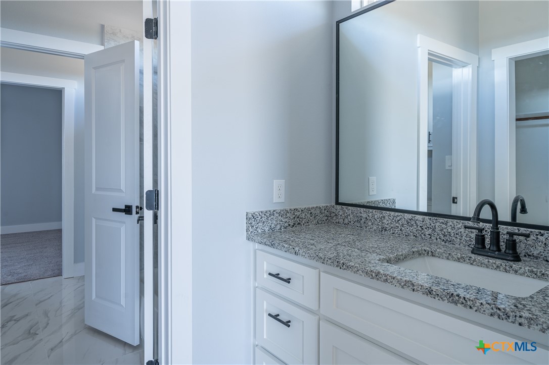 1000 Black Ankle Road Lockhart, TX 78644 - Photo 29 of 40 a bathroom with a granite countertop sink and a mirror
