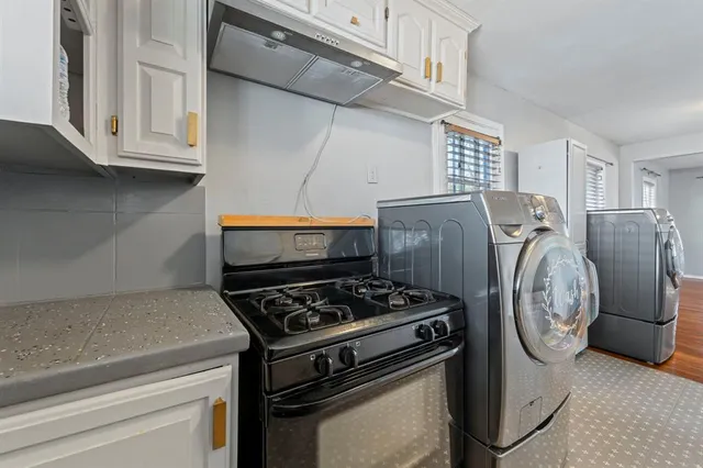 a kitchen with stainless steel appliances granite countertop a stove and a refrigerator