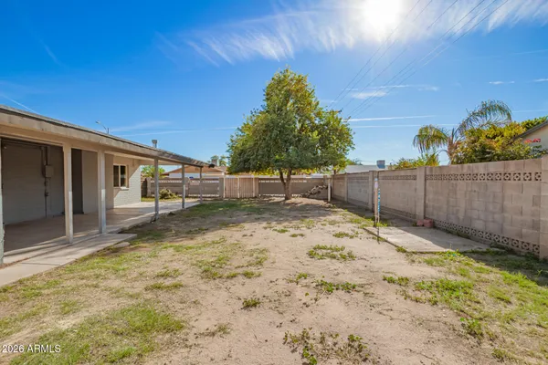 a backyard of a house with wooden fence