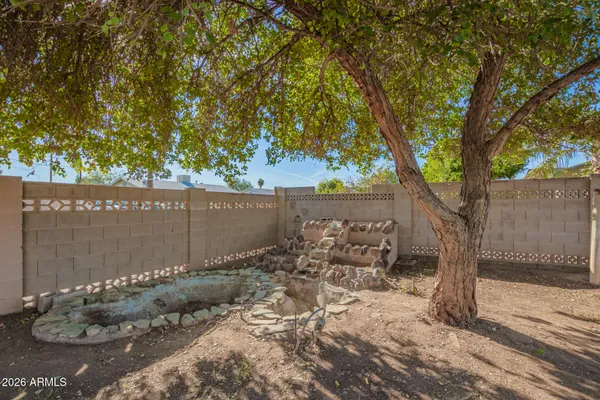 a backyard of a house with table and chairs
