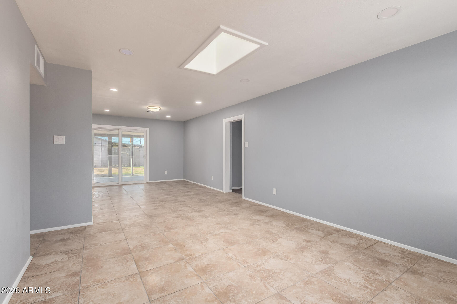 3802 North 79th Avenue Phoenix, AZ 85033 - Photo 4 of 28 a view of an empty room with a window