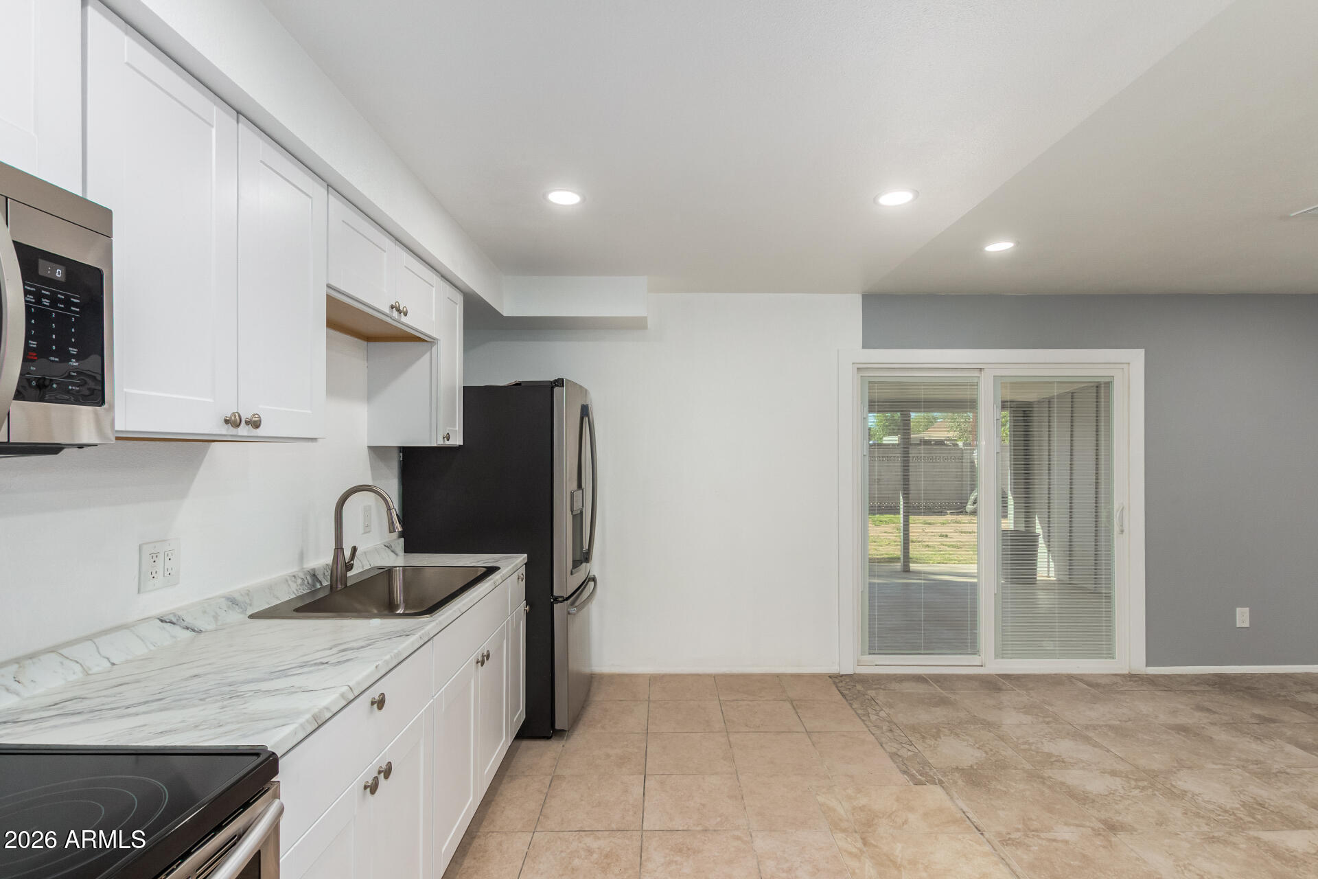3802 North 79th Avenue Phoenix, AZ 85033 - Photo 9 of 28 a kitchen with stainless steel appliances granite countertop a refrigerator and a sink