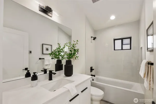 a bathroom with a sink a toilet and a bathtub