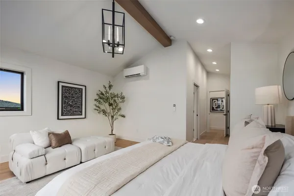 a bedroom with a large bed and a couch