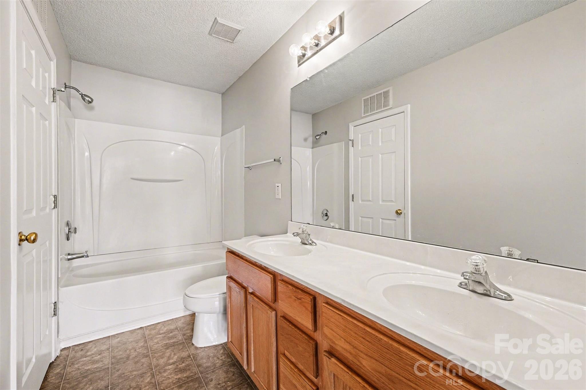 3201 Blythe Ridge Court Charlotte, NC 28213 - Photo 21 of 34 a spacious bathroom with a granite countertop sink a toilet and shower