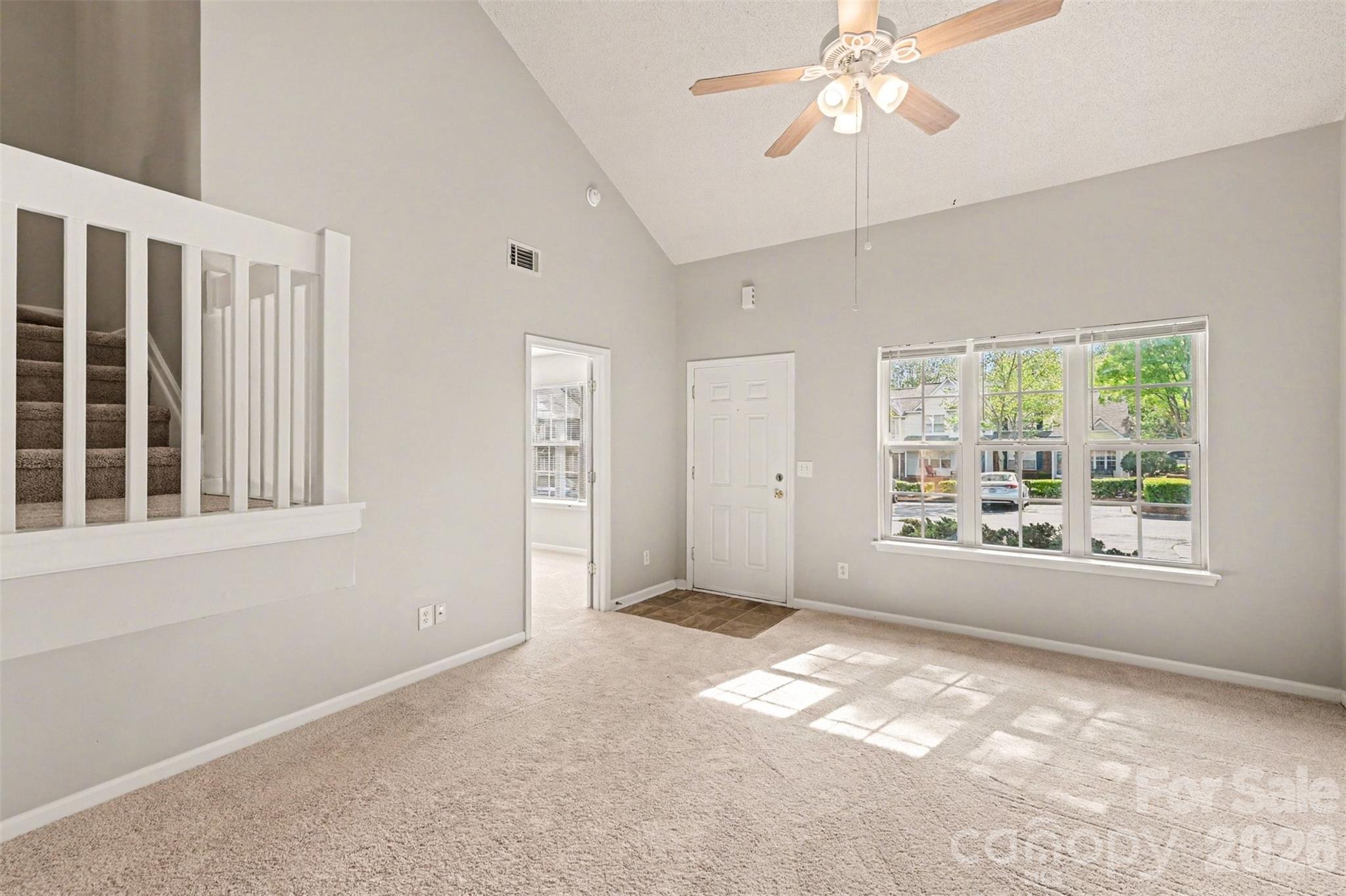 3201 Blythe Ridge Court Charlotte, NC 28213 - Photo 5 of 34 an empty room with chandelier fan and windows