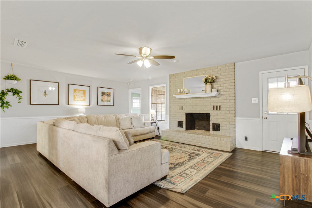 a living room with furniture and a fireplace