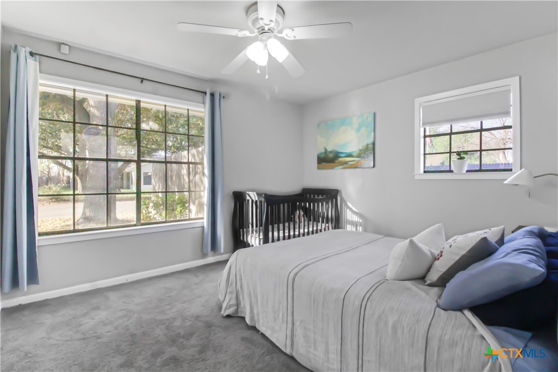 4314 Fox Trail Temple, TX 76504 - Photo 14 of 22 a bedroom with a bed and a chandelier