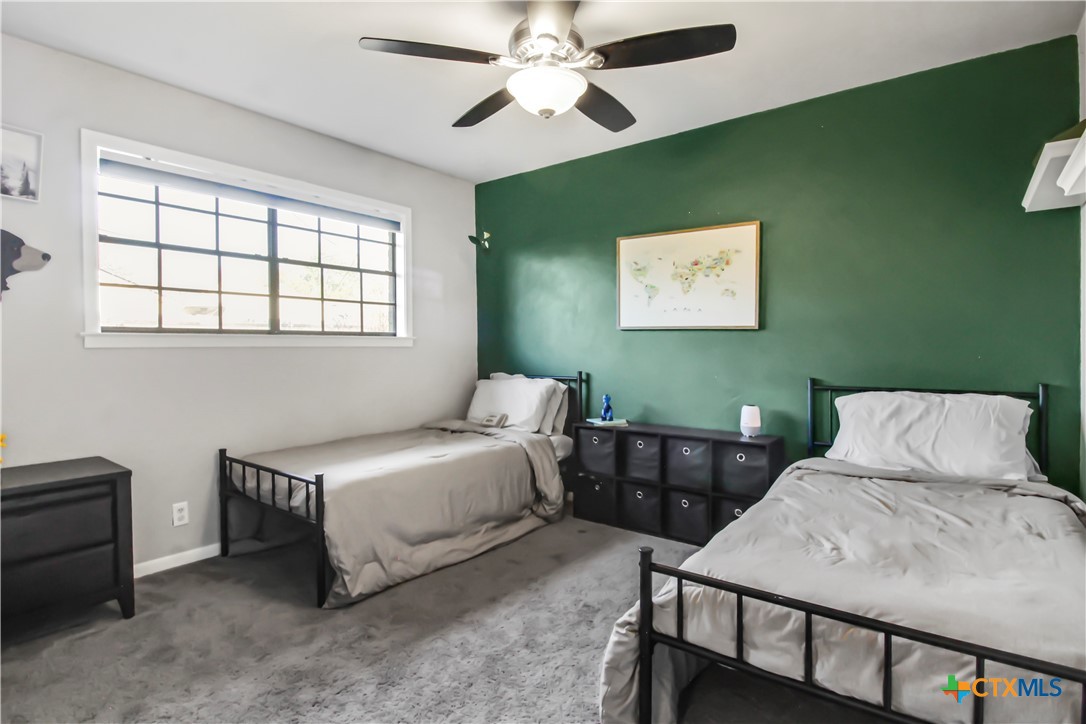4314 Fox Trail Temple, TX 76504 - Photo 17 of 22 a bedroom with a bed and a chandelier