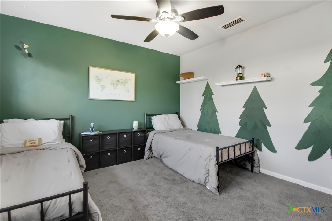 4314 Fox Trail Temple, TX 76504 - Photo 18 of 22 a bedroom with 2 bed and a chandelier