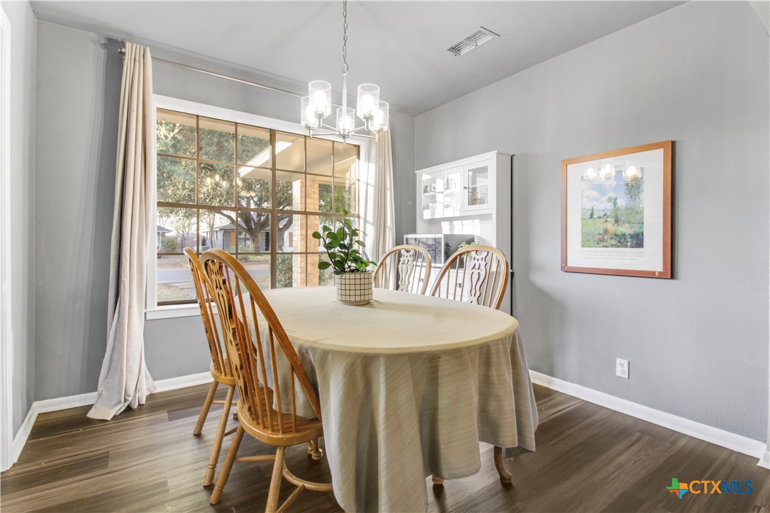 4314 Fox Trail Temple, TX 76504 - Photo 9 of 22 a view of a dining room with furniture a chandelier and wooden floor