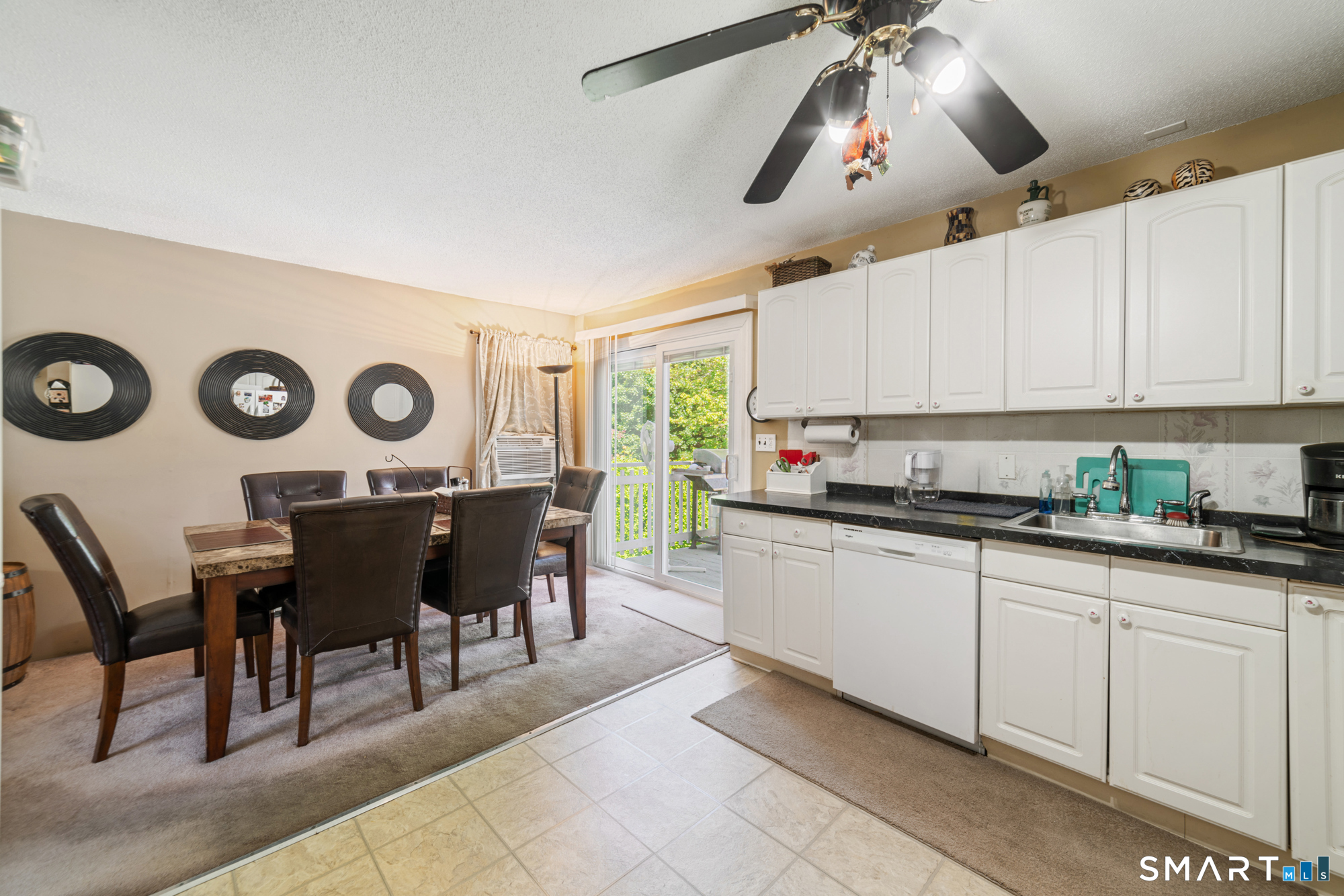 146 Highland Drive Waterbury, CT 06708 - Photo 8 of 31 a kitchen with a dining table chairs and white cabinets