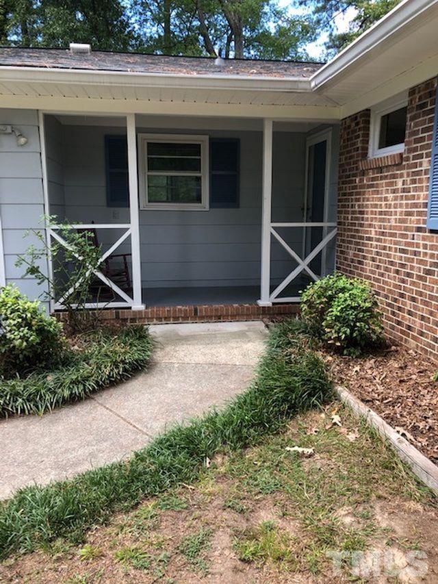 5400 Newhall Road Durham, NC 27713 - Photo 3 of 3 a house with trees in front of it