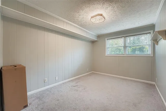 a kitchen with stainless steel appliances granite countertop white cabinets granite counter tops and a window