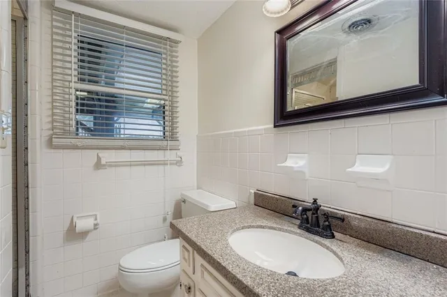 a view of a hallway with wooden floor and entryway