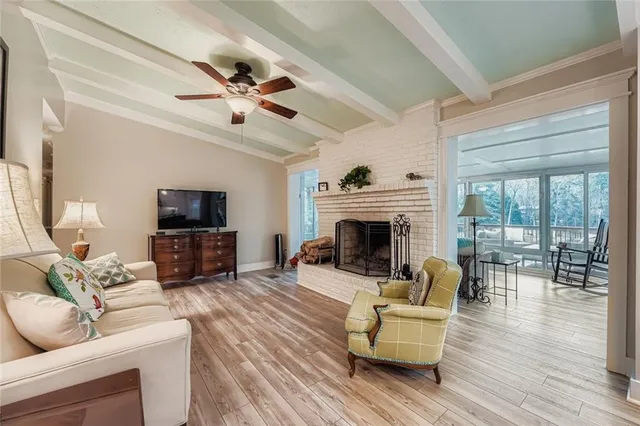 a living room with furniture and kitchen view
