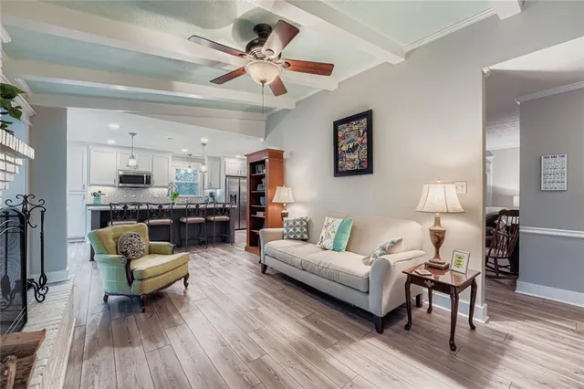 a view of a dining room with furniture a chandelier and wooden floor