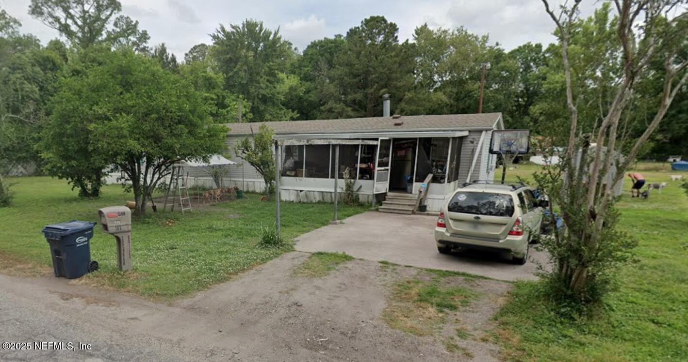 a view of a house with backyard sitting area and garden