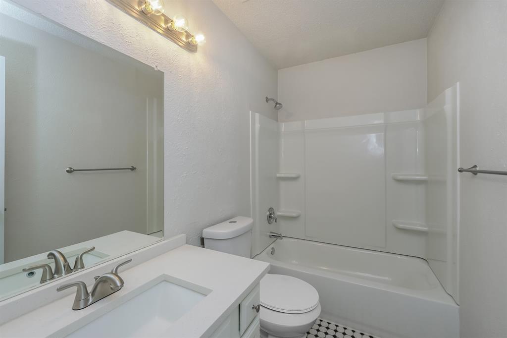 3805 Big Leaf Lane Fort Worth, TX 76137 - Photo 14 of 16 a white toilet sitting next to a bath tub