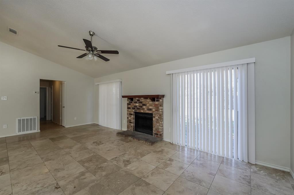 3805 Big Leaf Lane Fort Worth, TX 76137 - Photo 3 of 16 a view of an empty room with a fireplace and a window