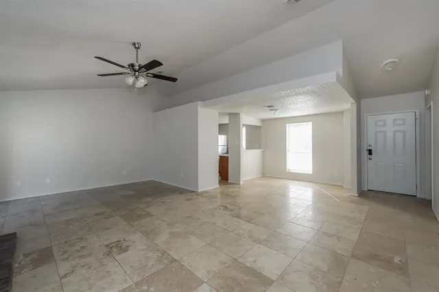 a view of a livingroom with a ceiling fan and window