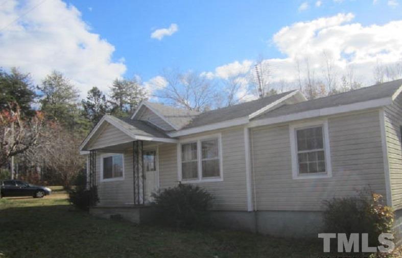 7866 Oxford Road Rougemont, NC 27572 - Photo 1 of 19 a front view of a house with garden