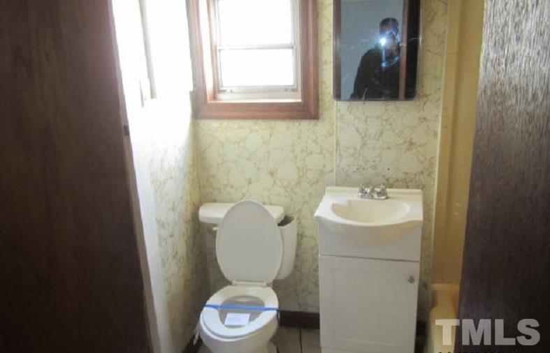 7866 Oxford Road Rougemont, NC 27572 - Photo 15 of 19 a bathroom with a toilet sink and mirror