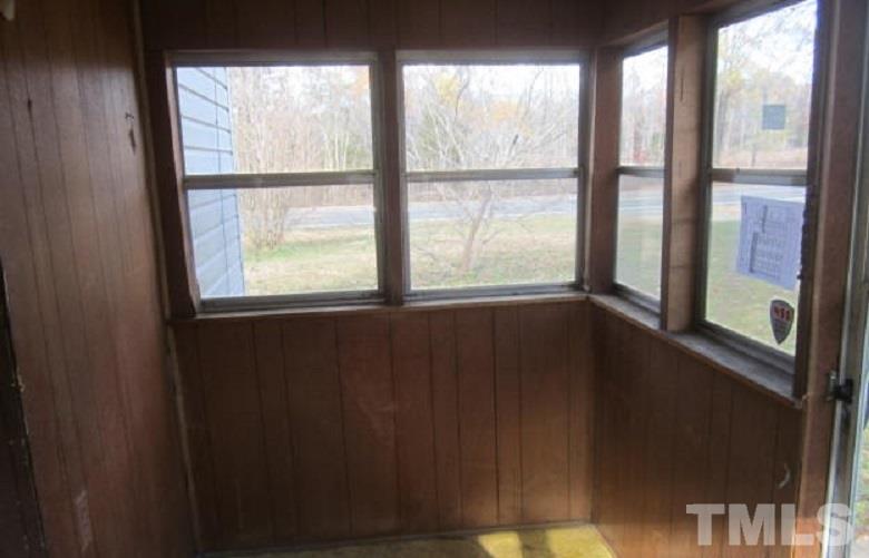 7866 Oxford Road Rougemont, NC 27572 - Photo 17 of 19 a view of an empty room with wooden floor and windows