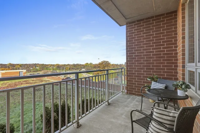 a view of a balcony with an outdoor seating