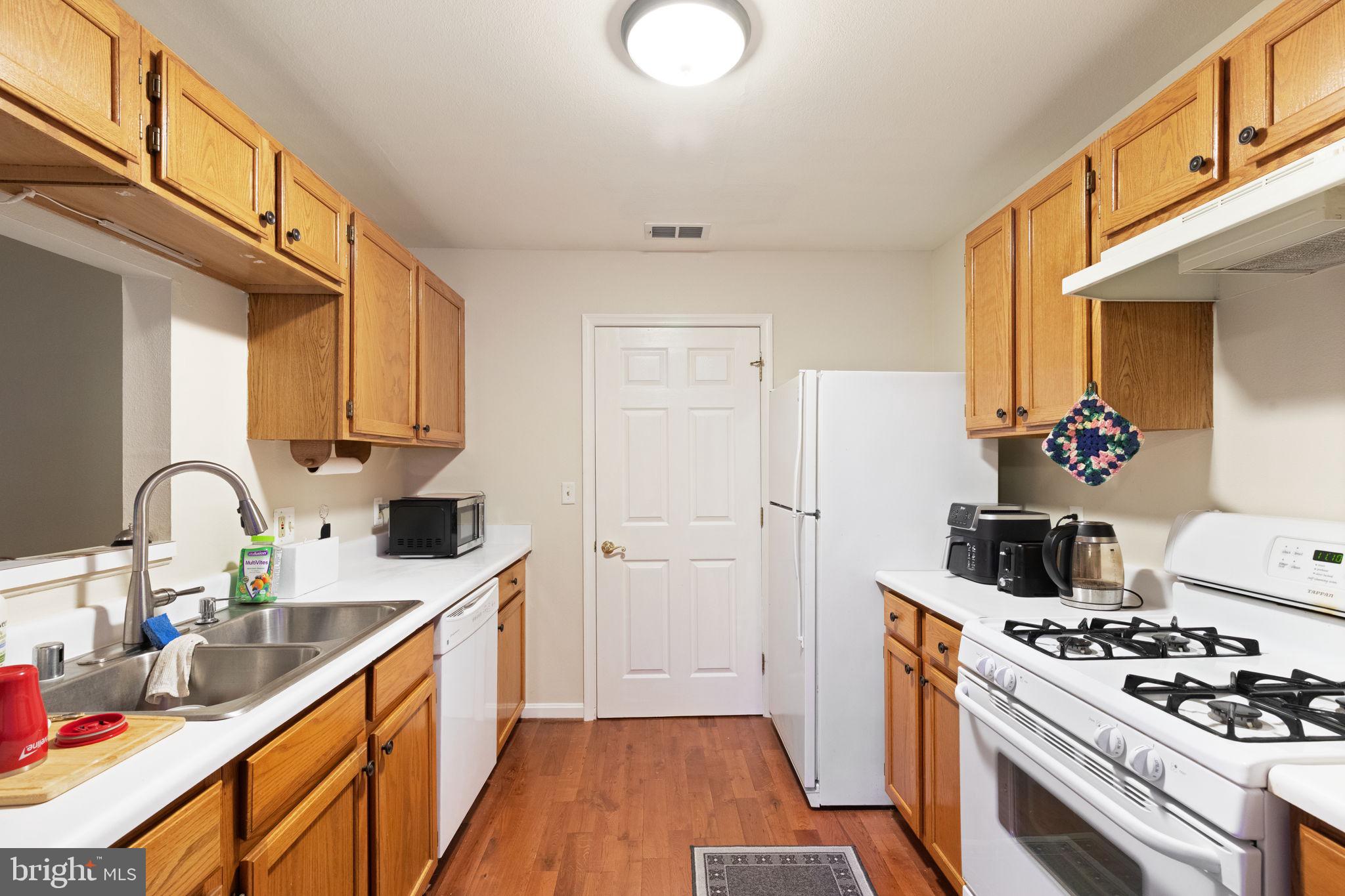 608 Churchill Road, Unit 608E Bel Air, MD 21014 - Photo 11 of 25 a kitchen with sink a stove and cabinets