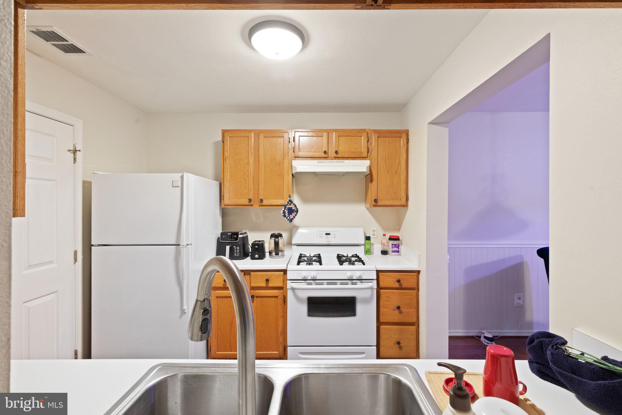 608 Churchill Road, Unit 608E Bel Air, MD 21014 - Photo 12 of 25 a kitchen with a white stove top oven and refrigerator