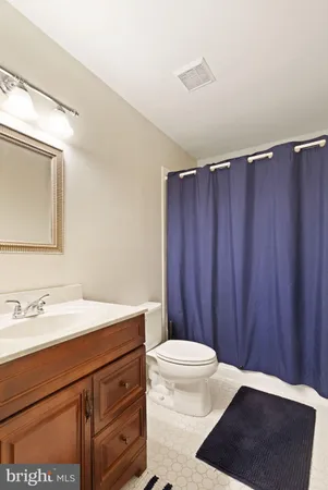 a bathroom with a sink a toilet a vanity and mirror