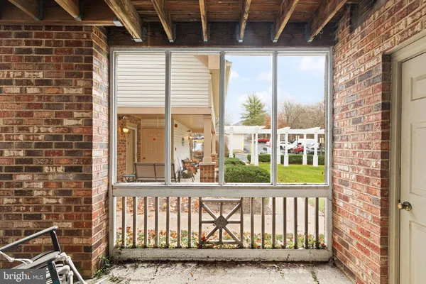 a view of a porch with a floor to ceiling window