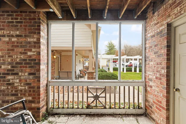 a view of a porch with a floor to ceiling window