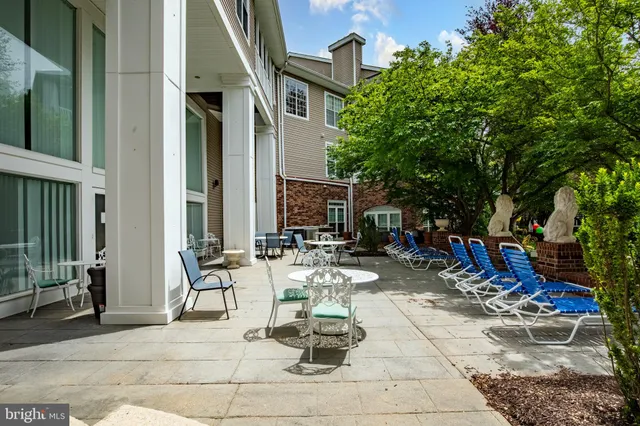 a view of the patio with dining table and chairs