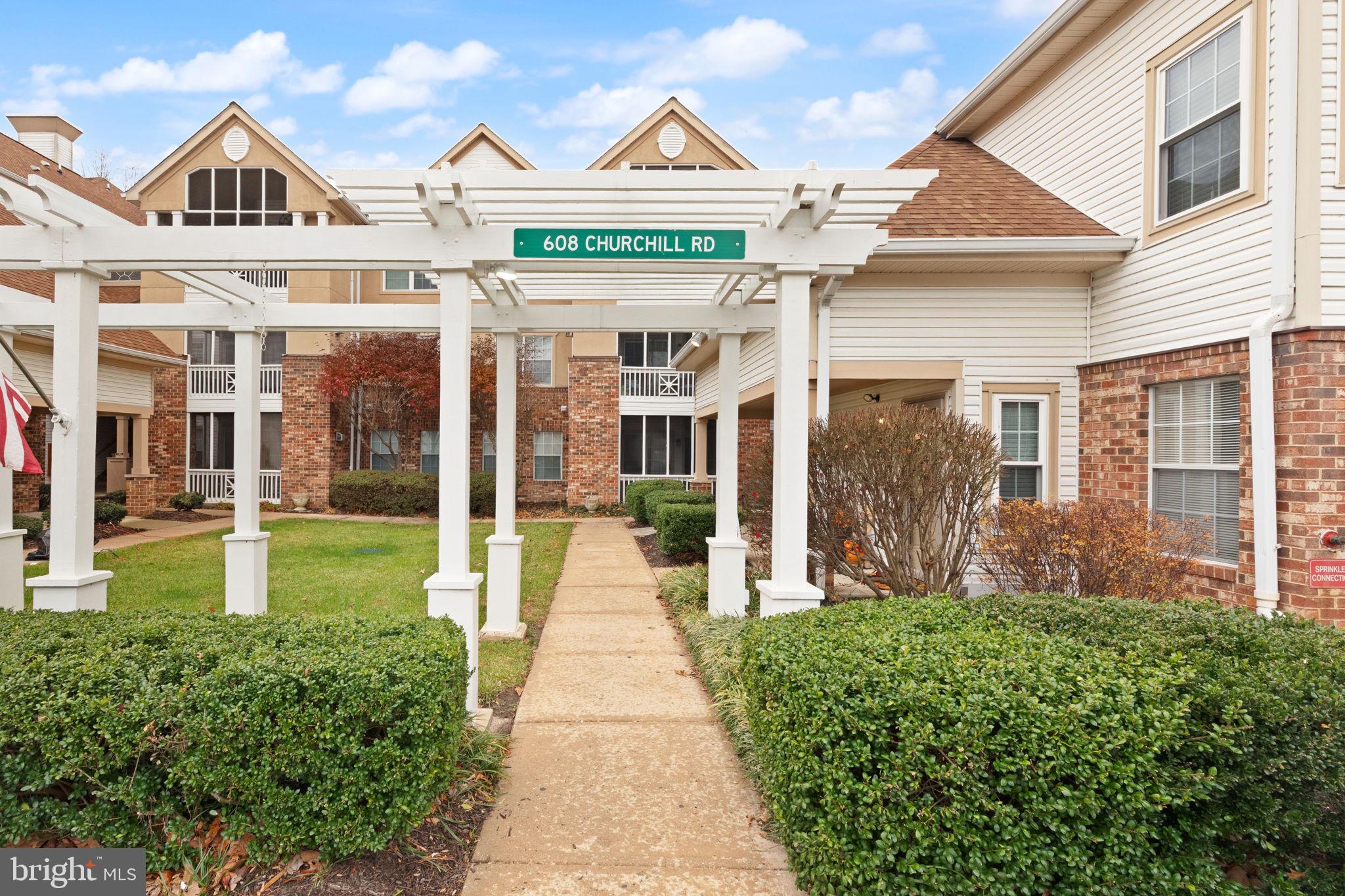 608 Churchill Road, Unit 608E Bel Air, MD 21014 - Photo 3 of 25 a view of a brick house with a yard plants and large tree