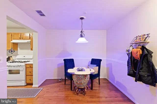 a dining room with furniture and wooden floor