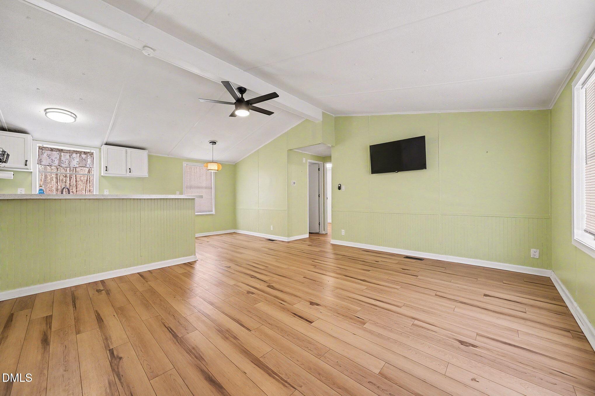 7223 Apple Mill Road Efland, NC 27243 - Photo 5 of 31 a view of empty room with wooden floor and fan