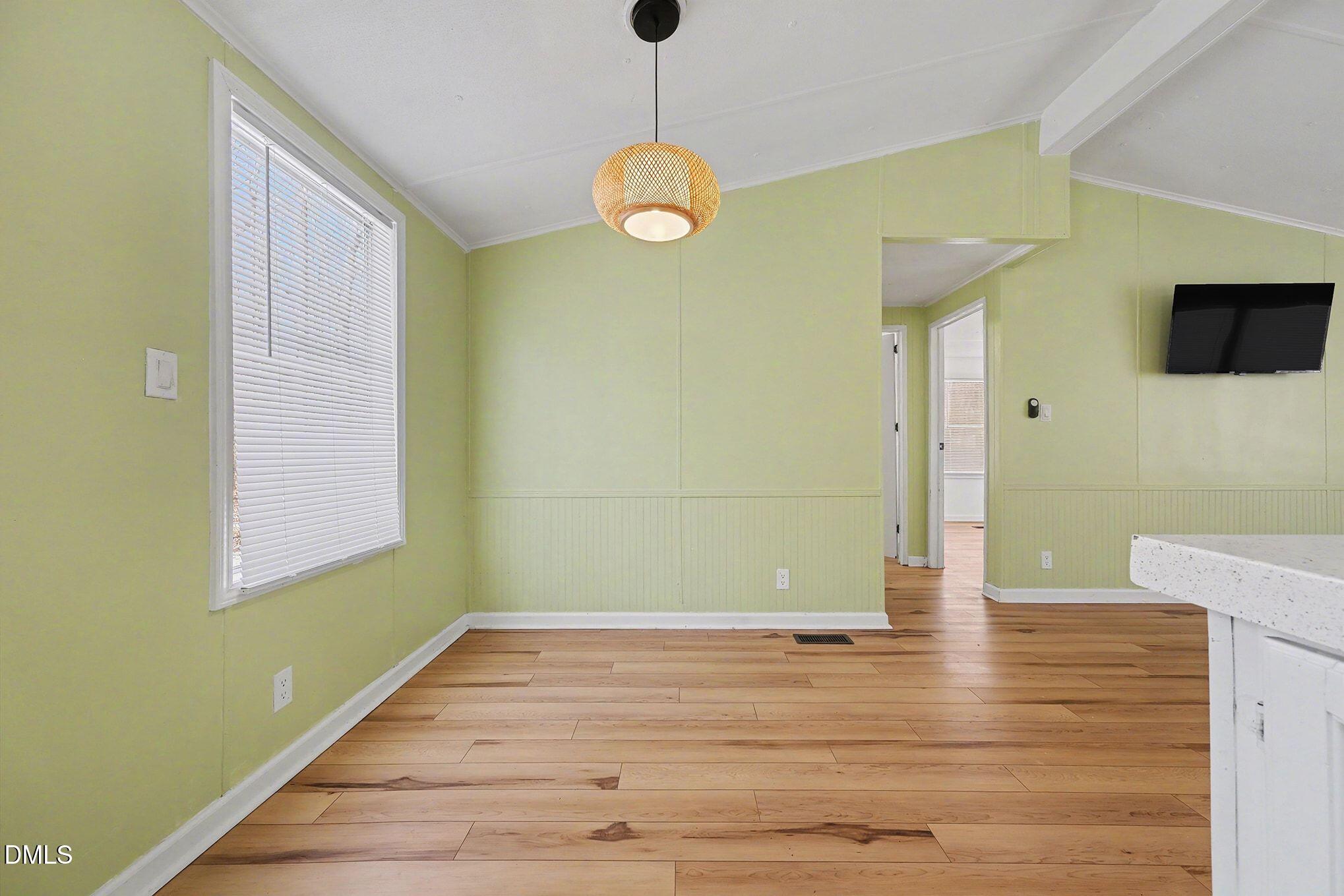 7223 Apple Mill Road Efland, NC 27243 - Photo 9 of 31 a view of an empty room with wooden floor and a window