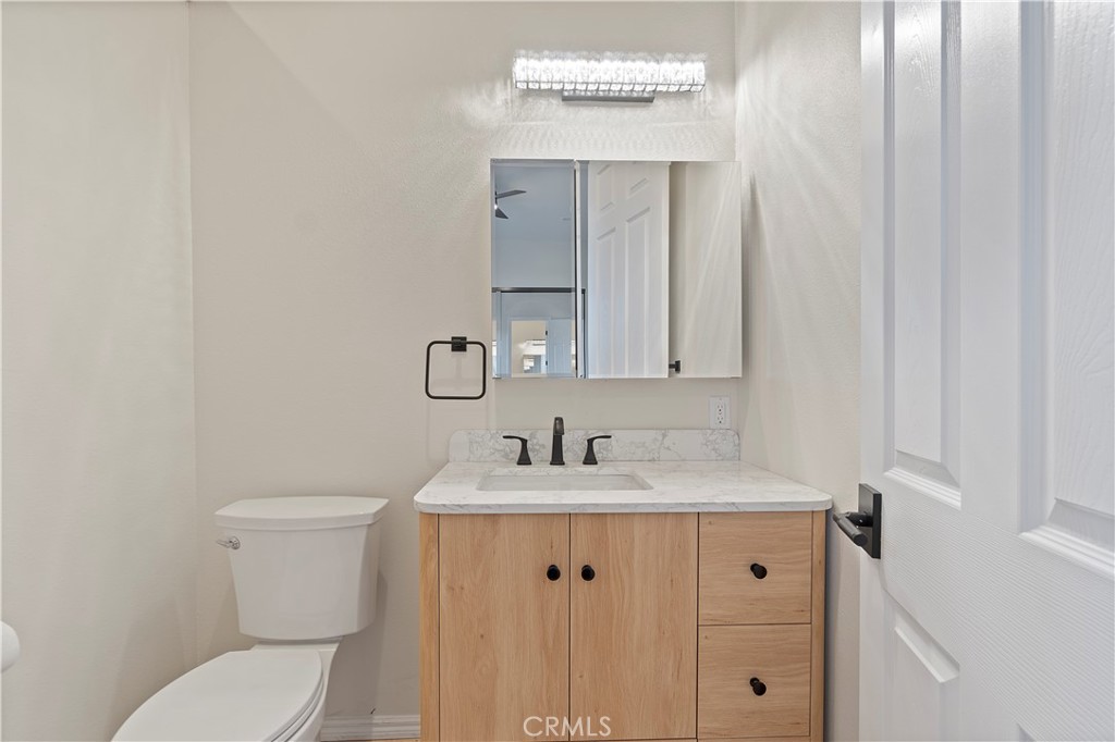 37420 Leta Drive Calimesa, CA 92320 - Photo 13 of 24 a bathroom with a toilet sink and mirror