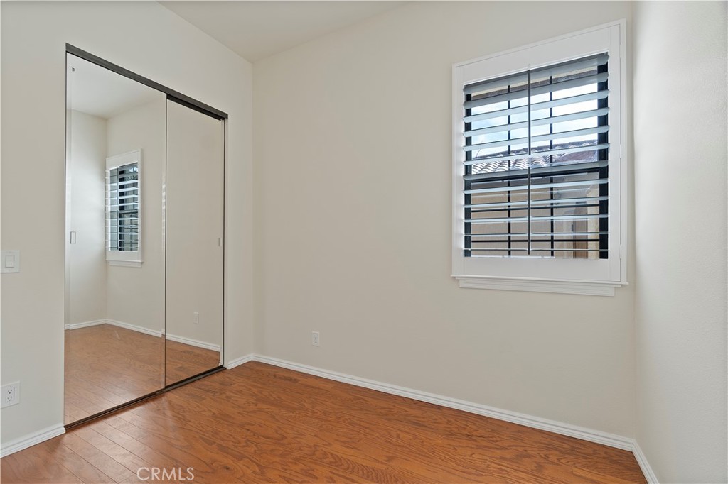 37420 Leta Drive Calimesa, CA 92320 - Photo 15 of 24 an empty room with wooden floor and windows
